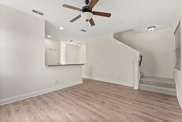 11 W Harding St Unit E, Orlando, FL 32806 - unfurnished living room featuring light wood-style floors, stairway, ceiling fan, and recessed lighting