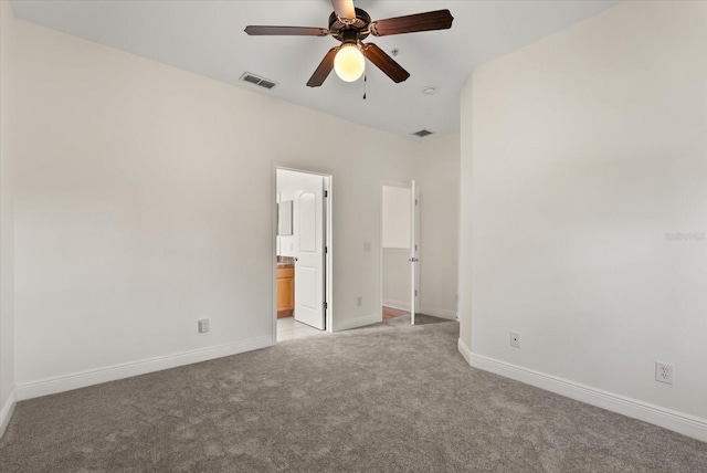 11 W Harding St Unit E, Orlando, FL 32806 - unfurnished bedroom with light colored carpet, ensuite bath, and a ceiling fan