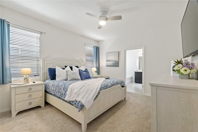 8020 Oak Shadow Ct, Davenport, FL 33837 - bedroom with light colored carpet, ceiling fan, and ensuite bathroom