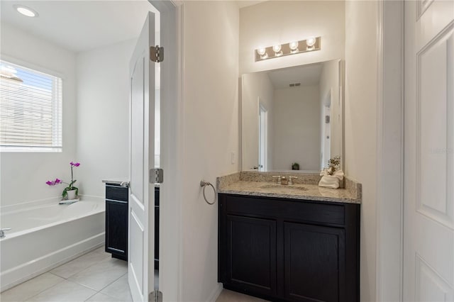 8020 Oak Shadow Ct, Davenport, FL 33837 - full bath with vanity, tile patterned floors, and a garden tub