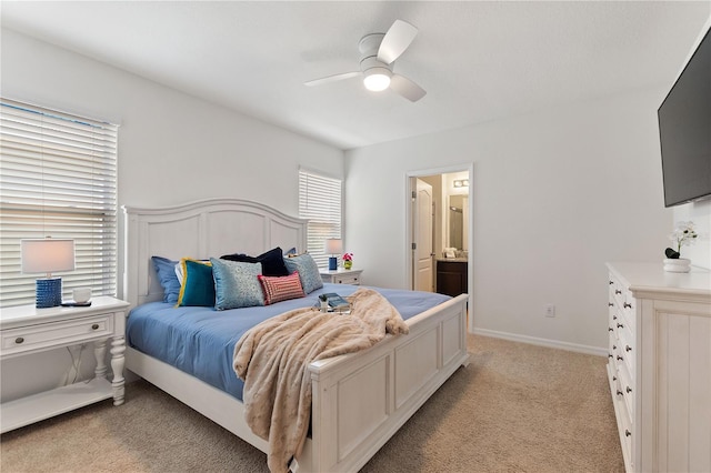 8020 Oak Shadow Ct, Davenport, FL 33837 - bedroom featuring light colored carpet, connected bathroom, and ceiling fan