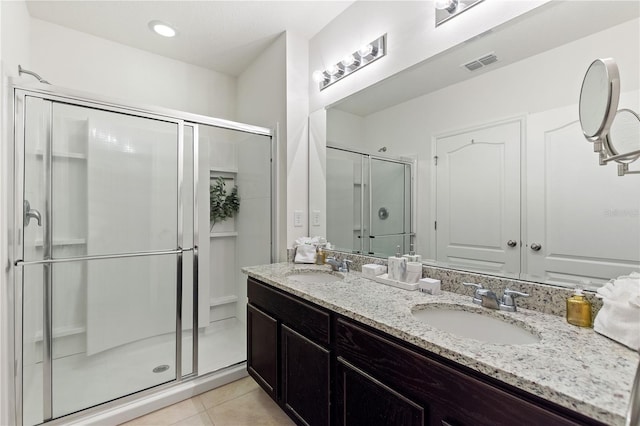 8020 Oak Shadow Ct, Davenport, FL 33837 - bathroom with a shower stall, double vanity, and tile patterned floors