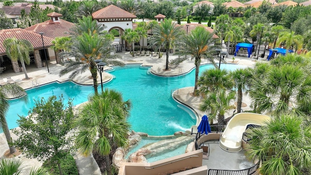 8020 Oak Shadow Ct, Davenport, FL 33837 - community pool featuring a patio area