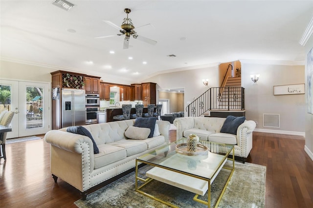 8445 Shady Glen Dr, Orlando, FL 32819 - living room featuring stairs, ceiling fan, ornamental molding, dark wood-style floors, and french doors