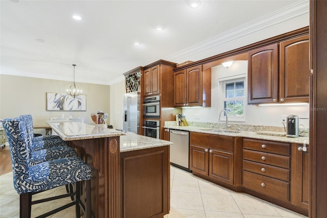 8445 Shady Glen Dr, Orlando, FL 32819 - kitchen featuring stainless steel appliances, a center island, a breakfast bar, light tile patterned floors, and light stone counters