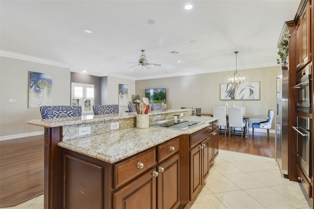8445 Shady Glen Dr, Orlando, FL 32819 - kitchen featuring electric cooktop, stainless steel oven, crown molding, a kitchen island, and ceiling fan