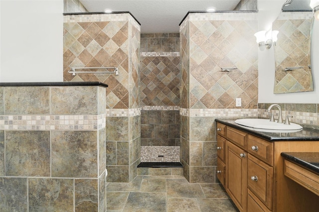 8445 Shady Glen Dr, Orlando, FL 32819 - bathroom featuring vanity, a walk in shower, and tile walls