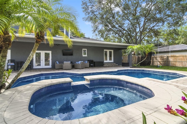 8445 Shady Glen Dr, Orlando, FL 32819 - view of swimming pool with french doors, a pool with connected hot tub, an outdoor living space, and a patio