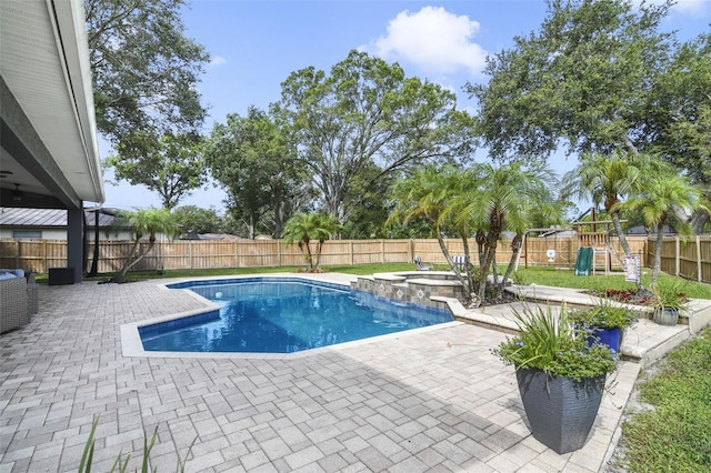 8445 Shady Glen Dr, Orlando, FL 32819 - view of swimming pool featuring a patio, a fenced backyard, a playground, and a pool with connected hot tub