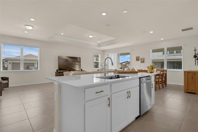 3702 Haddon Ave, Davenport, FL 33837 - kitchen with stainless steel dishwasher, light tile patterned floors, open floor plan, a kitchen island with sink, and light countertops