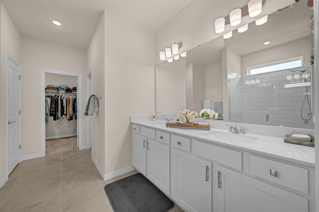 3702 Haddon Ave, Davenport, FL 33837 - full bathroom with double vanity, a stall shower, a walk in closet, recessed lighting, and tile patterned flooring