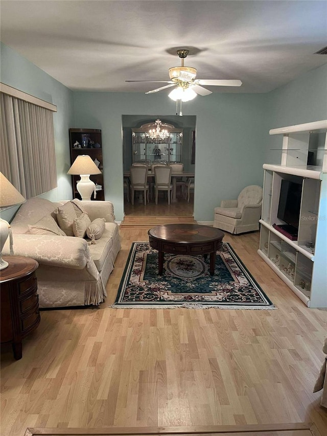 608 Knowles Rd, Brandon, FL 33511 - living room featuring ceiling fan, wood finished floors, and a chandelier