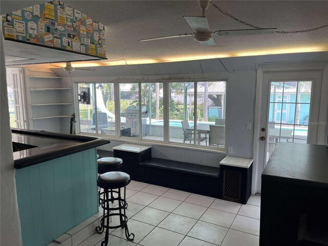 608 Knowles Rd, Brandon, FL 33511 - dining space featuring ceiling fan, light tile patterned floors, and a textured ceiling