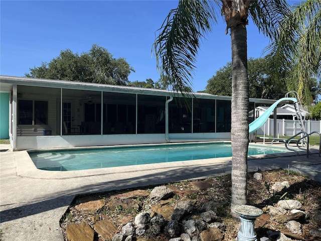 608 Knowles Rd, Brandon, FL 33511 - outdoor pool featuring a sunroom, a water slide, and a patio
