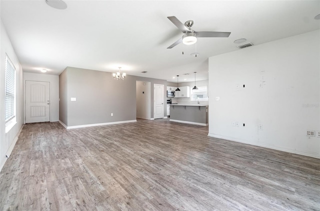 4684 Glencrest Loop, Saint Cloud, FL 34772 - unfurnished living room featuring a chandelier, wood finished floors, and ceiling fan