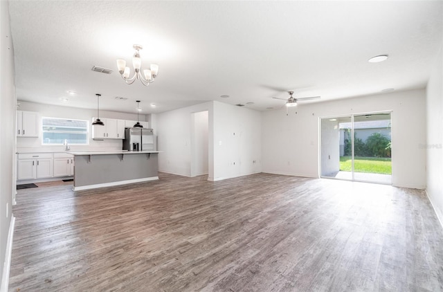 4684 Glencrest Loop, Saint Cloud, FL 34772 - unfurnished living room with a chandelier, light wood-style floors, and a ceiling fan