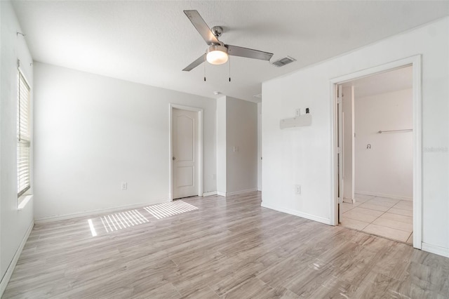 4684 Glencrest Loop, Saint Cloud, FL 34772 - unfurnished bedroom with light wood-style flooring, multiple windows, and a ceiling fan