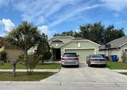 2016 Newtown Rd, Groveland, FL 34736 - ranch-style home featuring concrete driveway and a garage