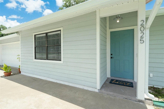 2025 Mango Tree Dr, Edgewater, FL 32141 - view of exterior entry with a garage