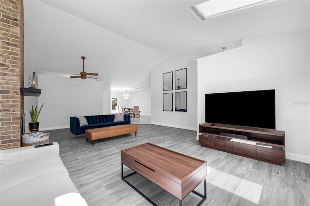2025 Mango Tree Dr, Edgewater, FL 32141 - living area featuring wood finished floors, vaulted ceiling, and a ceiling fan
