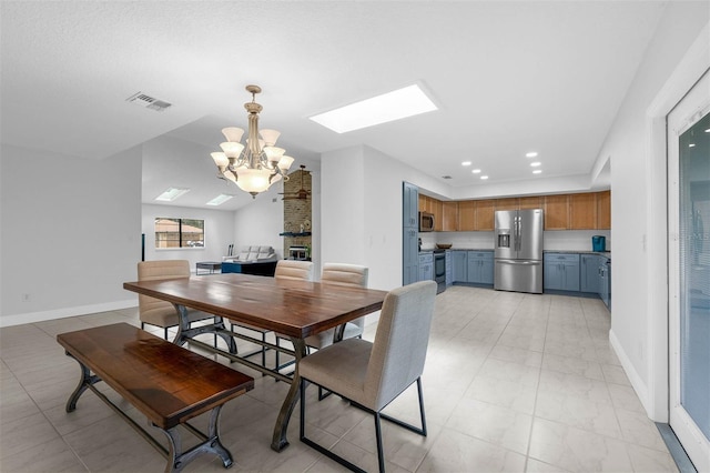 2025 Mango Tree Dr, Edgewater, FL 32141 - dining room featuring a chandelier, a skylight, light marble finish flooring, and recessed lighting