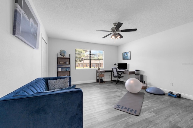 2025 Mango Tree Dr, Edgewater, FL 32141 - home office with wood finished floors, ceiling fan, and a textured ceiling