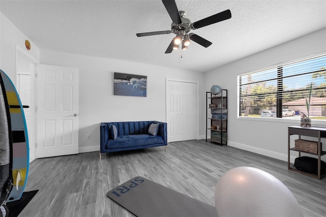 2025 Mango Tree Dr, Edgewater, FL 32141 - exercise room featuring a textured ceiling, wood finished floors, and ceiling fan
