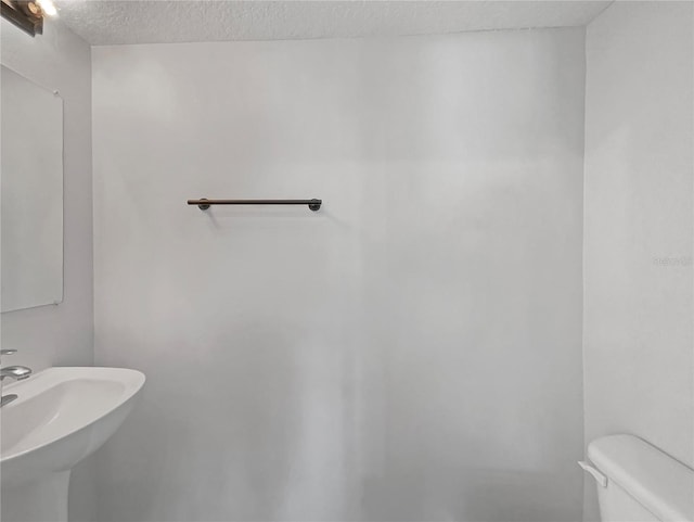1301 Brenway Dr, Mascotte, FL 34753 - half bathroom with a textured ceiling and toilet