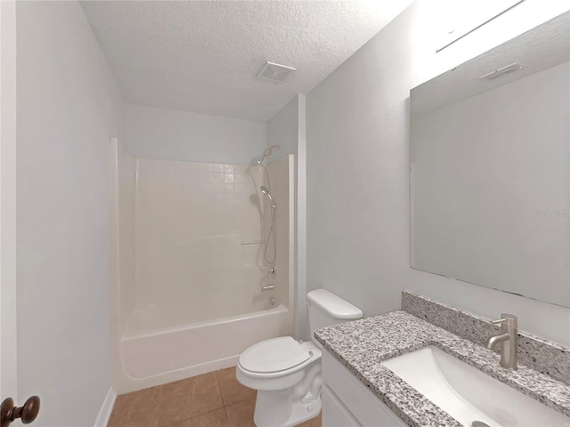 1301 Brenway Dr, Mascotte, FL 34753 - full bath with vanity, a textured ceiling, tile patterned flooring, and washtub / shower combination