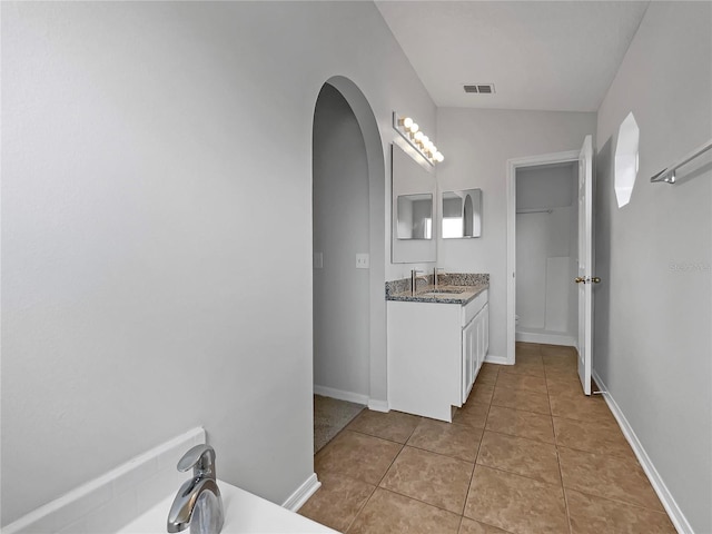 1301 Brenway Dr, Mascotte, FL 34753 - bathroom with vanity, a bathtub, and tile patterned flooring