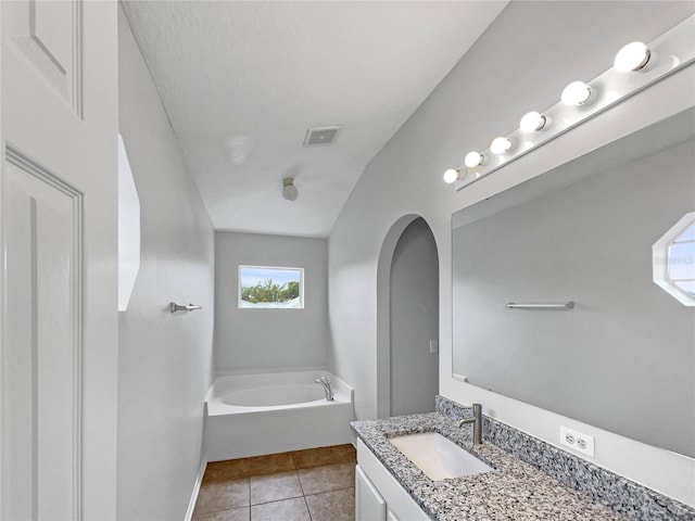 1301 Brenway Dr, Mascotte, FL 34753 - full bath featuring vanity, a bath, and tile patterned floors