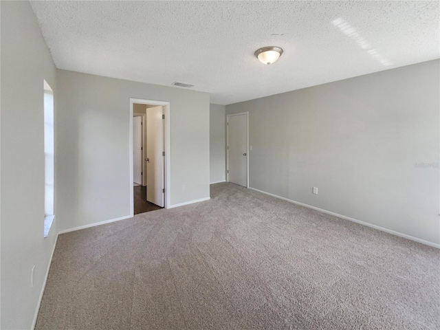 6460 Preakness Dr, Orlando, FL 32818 - unfurnished bedroom featuring carpet floors and a textured ceiling