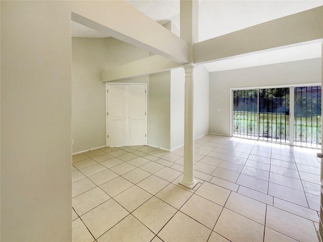 6460 Preakness Dr, Orlando, FL 32818 - spare room with lofted ceiling, light tile patterned floors, and decorative columns