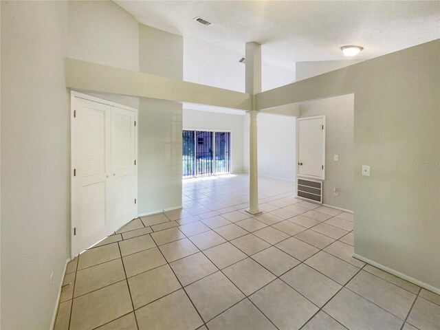 6460 Preakness Dr, Orlando, FL 32818 - unfurnished room with high vaulted ceiling, light tile patterned flooring, and decorative columns