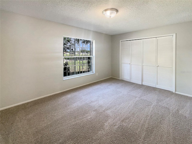 6460 Preakness Dr, Orlando, FL 32818 - unfurnished bedroom with carpet, a textured ceiling, and a closet