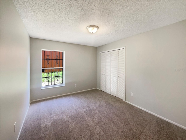 6460 Preakness Dr, Orlando, FL 32818 - unfurnished bedroom with carpet floors, a closet, and a textured ceiling