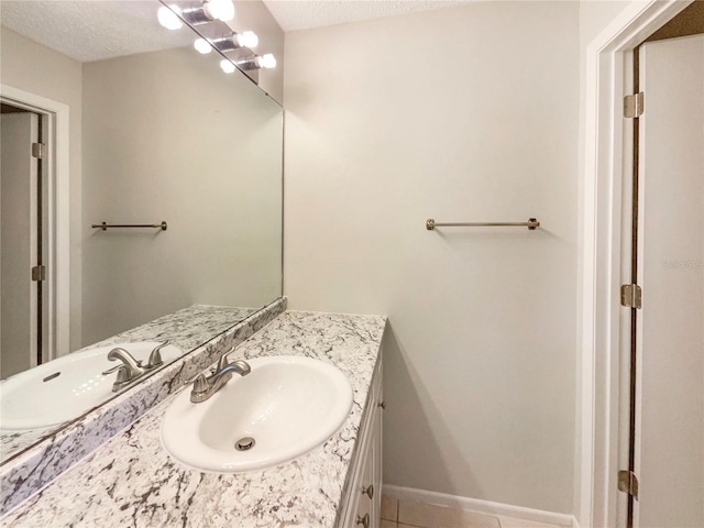 6460 Preakness Dr, Orlando, FL 32818 - bathroom featuring vanity, tile patterned floors, and a textured ceiling