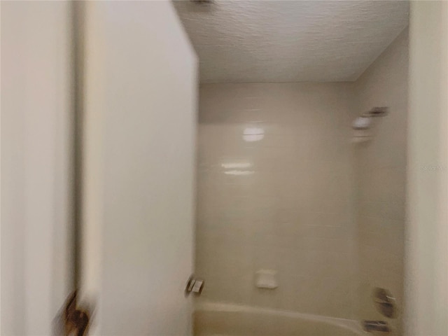 6460 Preakness Dr, Orlando, FL 32818 - bathroom featuring  shower combination and a textured ceiling