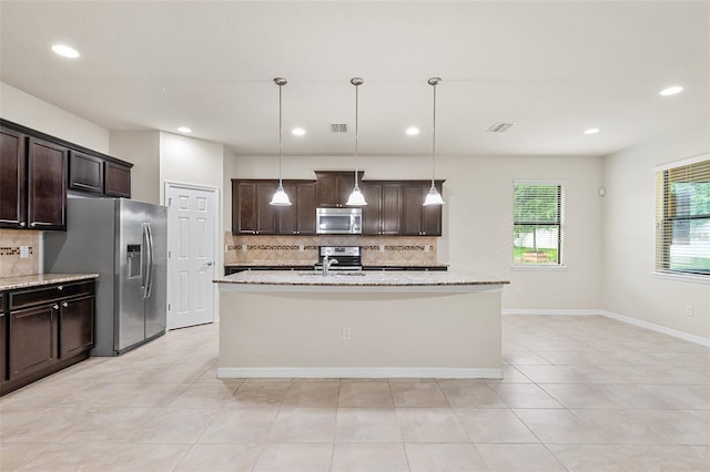 2236 Landside Dr, Valrico, FL 33594 - kitchen with stainless steel appliances, backsplash, dark brown cabinets, recessed lighting, and light stone countertops