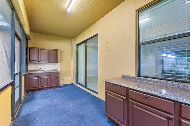 2236 Landside Dr, Valrico, FL 33594 - kitchen featuring dark colored carpet and a textured ceiling