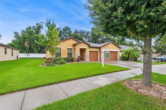 2236 Landside Dr, Valrico, FL 33594 - ranch-style home with stucco siding, an attached garage, concrete driveway, and stone siding