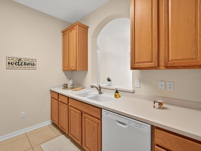 1353 Venezia Ct Unit 205, Davenport, FL 33896 - kitchen with dishwasher, light tile patterned floors, light countertops, and arched walkways