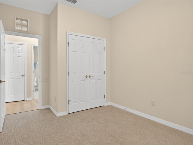 1353 Venezia Ct Unit 205, Davenport, FL 33896 - unfurnished bedroom featuring light colored carpet and a closet