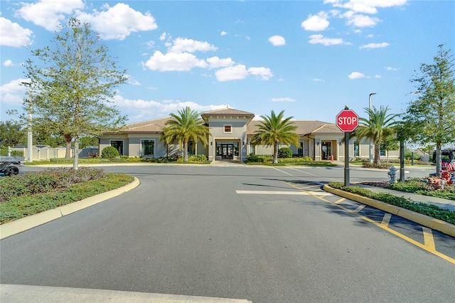 1353 Venezia Ct Unit 205, Davenport, FL 33896 - view of asphalt road with traffic signs, curbs, and street lighting