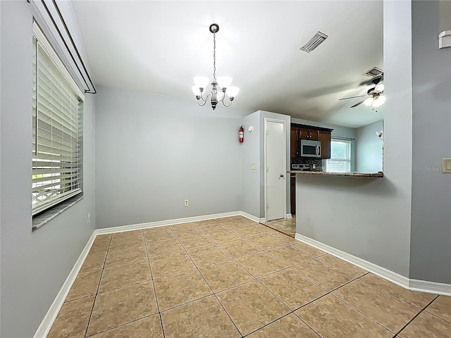 10901 Peppersong Dr, Riverview, FL 33578 - unfurnished dining area with a chandelier, light tile patterned flooring, and ceiling fan