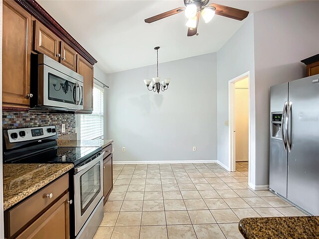 10901 Peppersong Dr, Riverview, FL 33578 - kitchen with stainless steel appliances, lofted ceiling, ceiling fan, a chandelier, and decorative backsplash