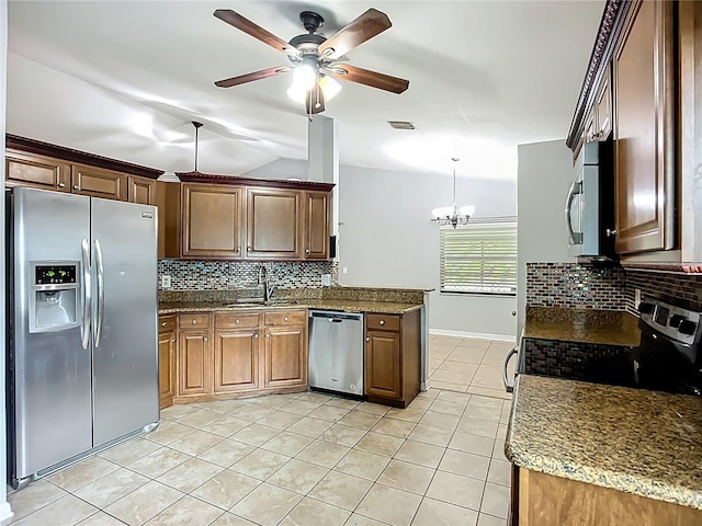10901 Peppersong Dr, Riverview, FL 33578 - kitchen featuring appliances with stainless steel finishes, light tile patterned floors, decorative backsplash, a ceiling fan, and a peninsula