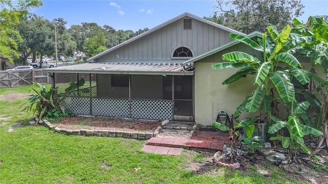 10901 Peppersong Dr, Riverview, FL 33578 - back of property with a sunroom and a metal roof