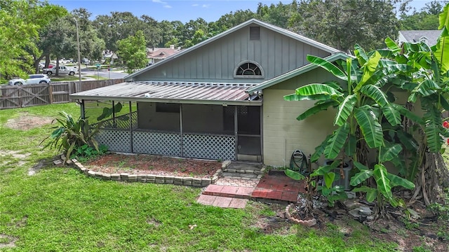 10901 Peppersong Dr, Riverview, FL 33578 - rear view of property with a sunroom and a metal roof