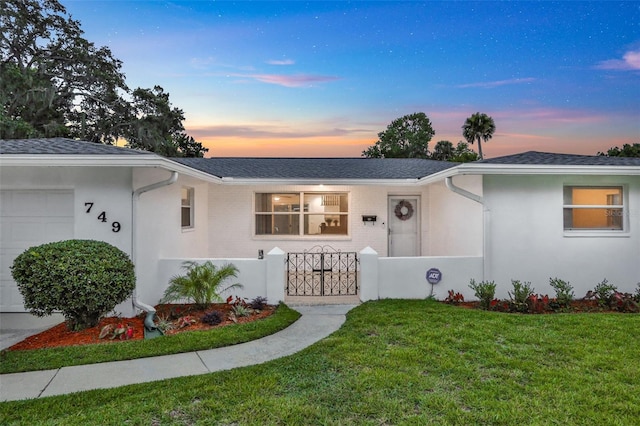 749 Ridge Blvd, South Daytona, FL 32119 - ranch-style home featuring a gate, a garage, a fenced front yard, and stucco siding